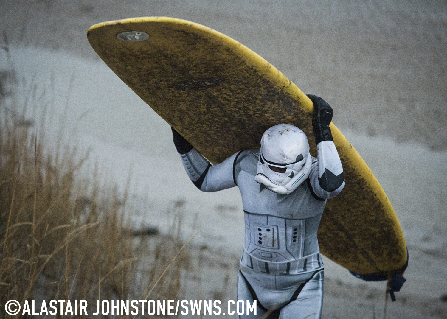 A surfer dressed as a Star Wars Stormtrooper after surfing one section of the Severn Bore on the River Severn in Gloucestershire, England. November 27 2015.  See SWNS story SWTROOPER: There was an unworldly sight in the Forest of Dean this morning (Friday 27th November) when a trio of Star Wars Stormtroopers surfed the spectacular Severn Bore. Key scenes from the upcoming Star Wars episode VII were filmed in nearby Puzzlewood and can be seen several times in the trailer.  Swapping the Death Star for surfboards, the elite soldiers of the Galactic Empire took to the waves to mark the release of the highly anticipated new Star Wars film and a new TV & Movie Trail. The Forest of Dean’s atmospheric and picturesque location provided a natural stage for the film, which director J.J Abrams referenced in a thank you letter to all of the movie's cast and crew.
