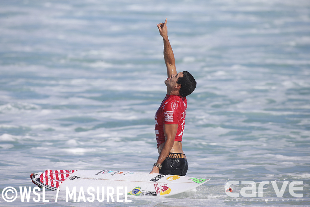 Adriano De Souza of Brasil (pictured) points to the sky after his Quarterfinal victory at the Buillabong Pipe Masters on Thursday December 17, 2015.