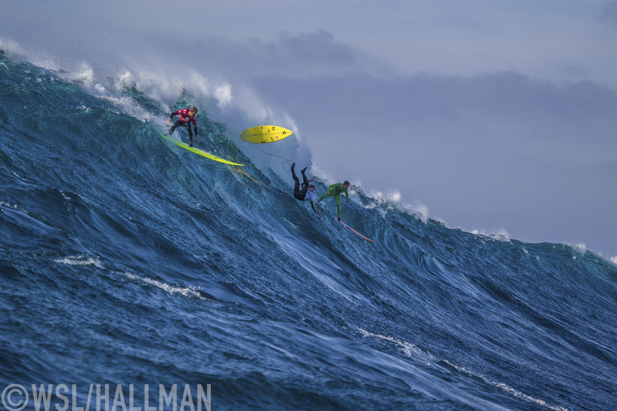 Josh Kerr of Australia now residing in USA (red), Carlos Burle of Brasil (white) and Nic Lamb of the USA (green) ride a wave together during the FInal of the Todos Santos Challenge in monstorous 30 - 40ft surf on Sunday January 17, 2015.