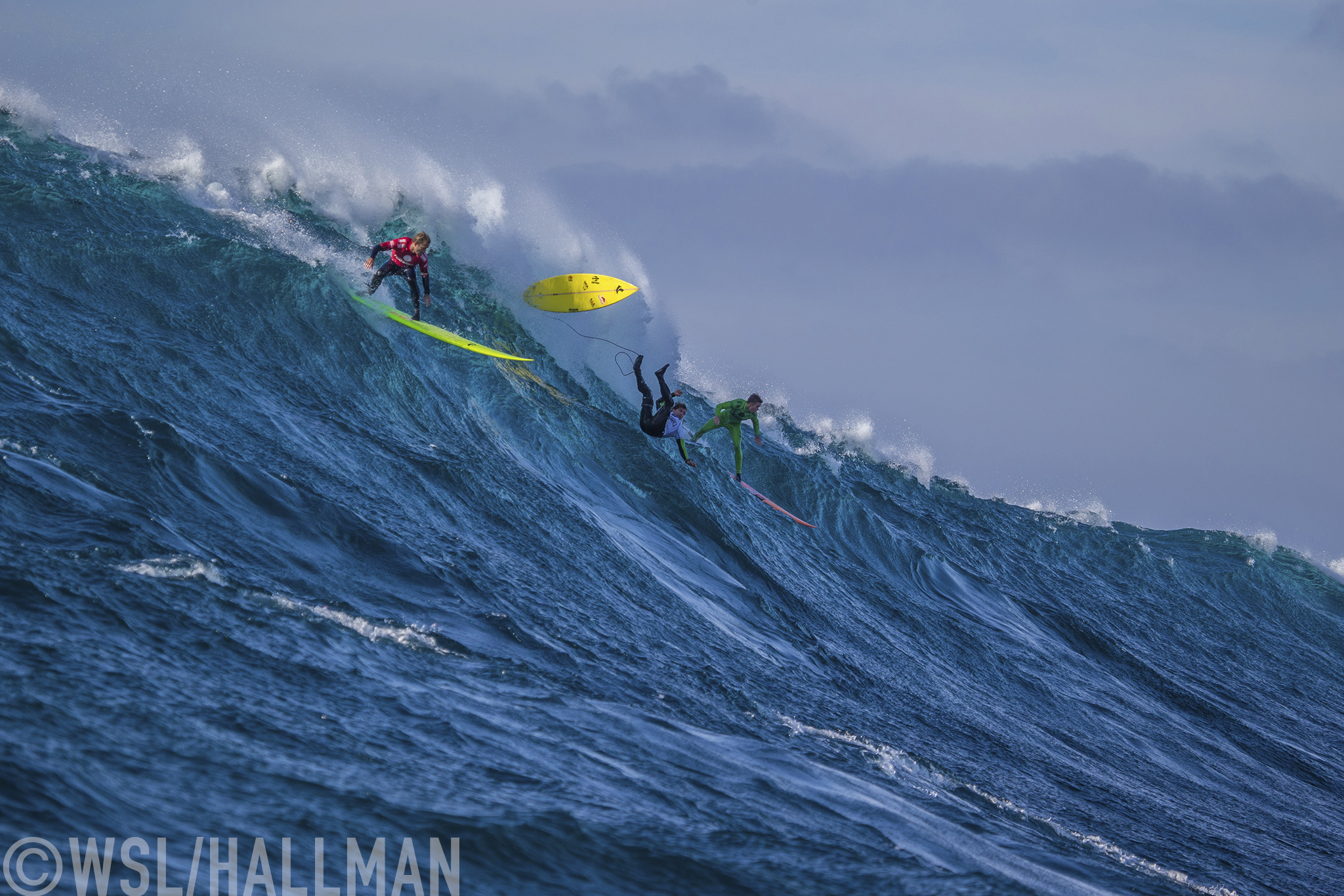 Josh Kerr of Australia now residing in USA (red), Carlos Burle of Brasil (white) and Nic Lamb of the USA (green) ride a wave together during the FInal of the Todos Santos Challenge in monstorous 30 - 40ft surf on Sunday January 17, 2015.