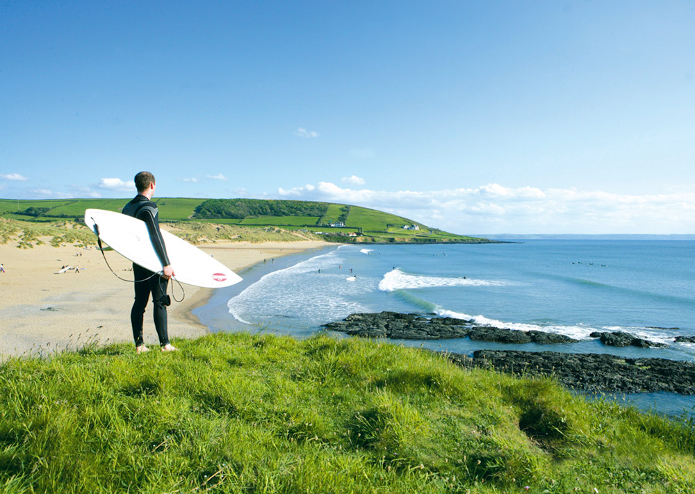 Surfer-overlooking-Croyde-Bay