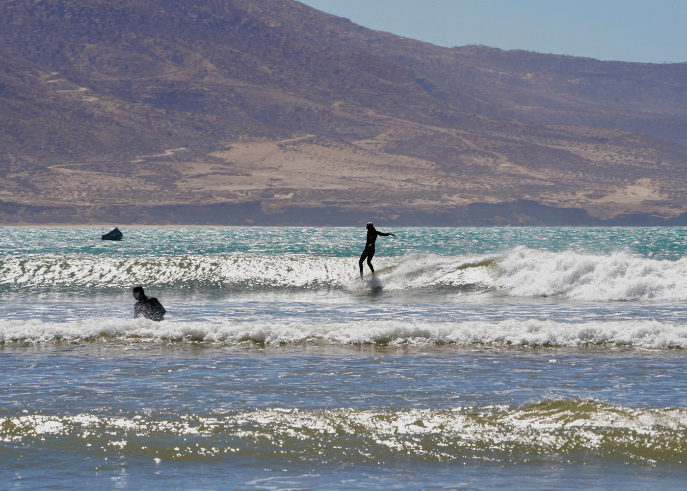 A girl surfing on Surf With Amigas retreat in Morocco