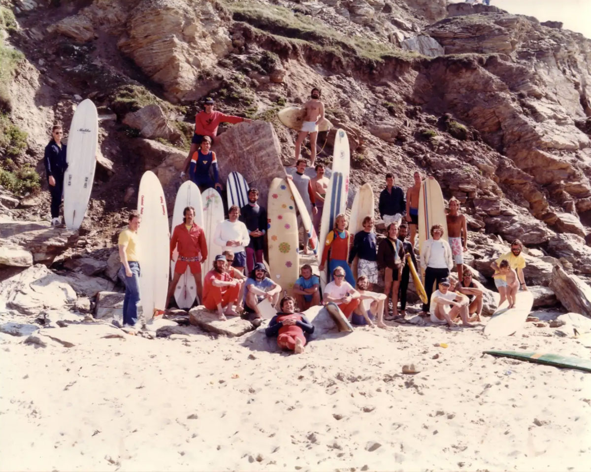 Surfers and longboards gathered on a Cornish beach at the Malibu Masters in 1986